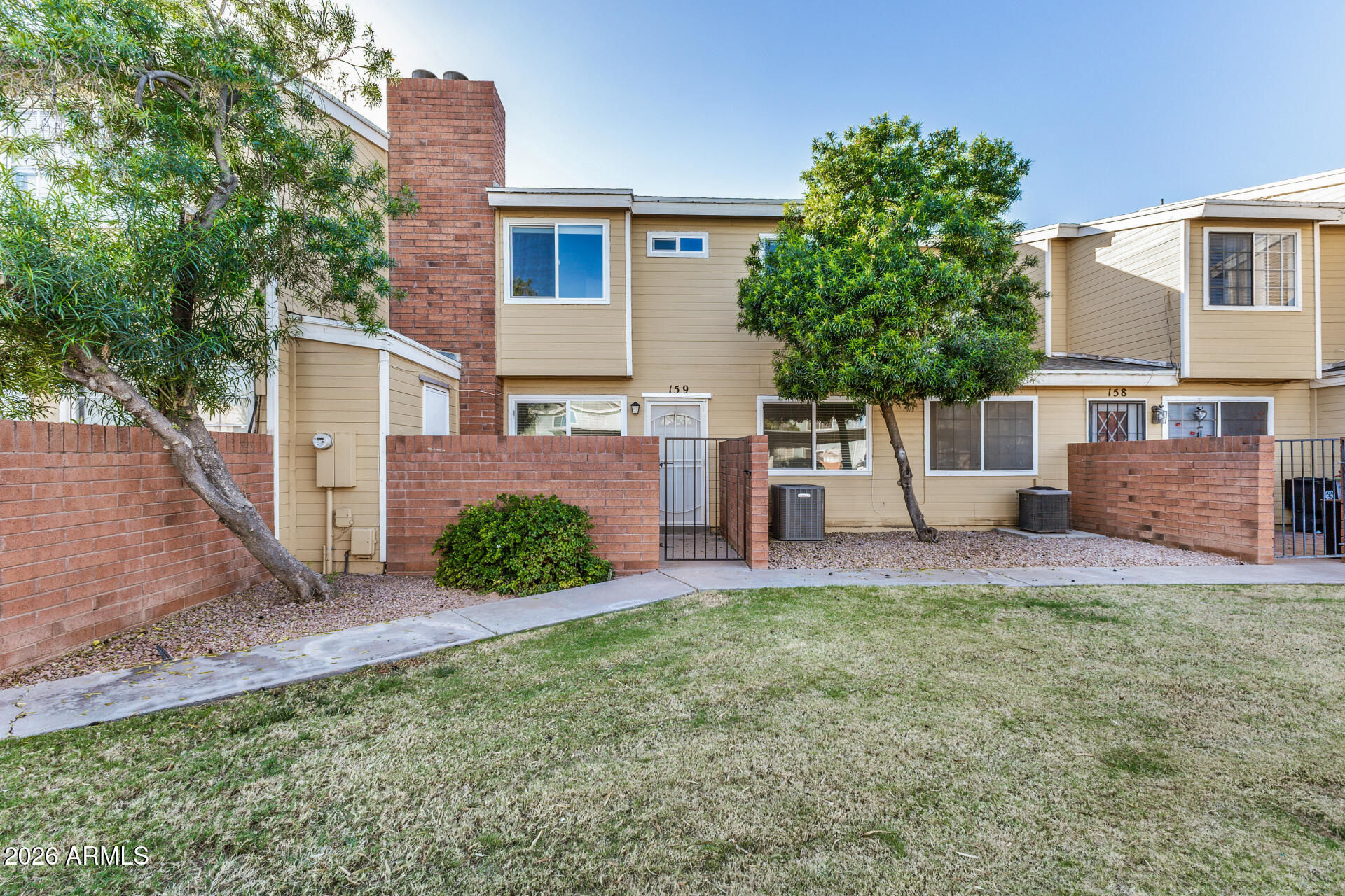 510 North Alma School Road, Unit 159 Mesa, AZ 85201 - Photo 27 of 31 a view of a house with a yard and a large tree