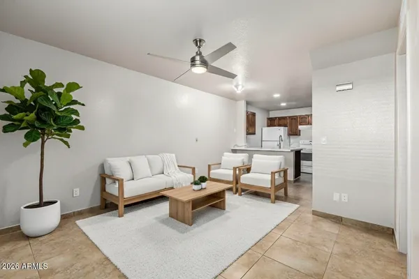 a living room with furniture and a potted plant