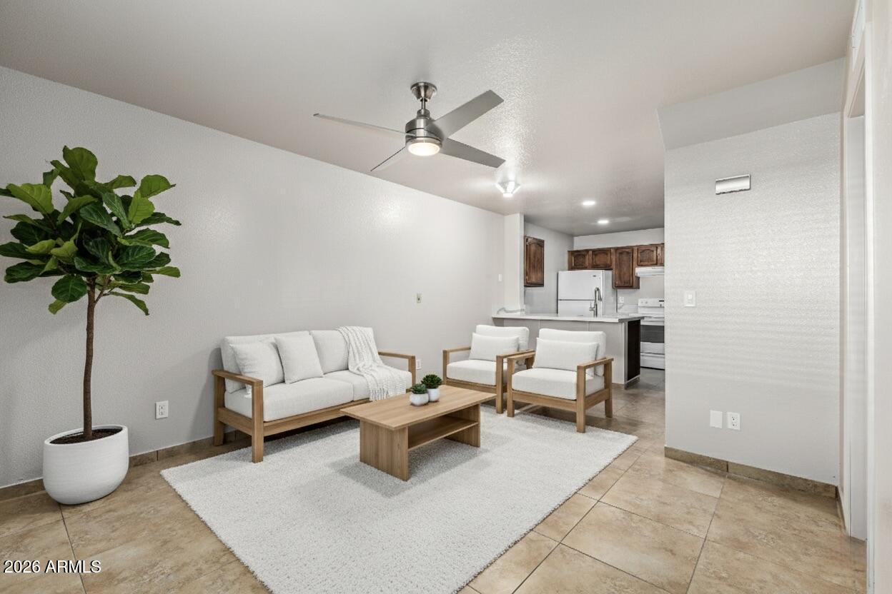 510 North Alma School Road, Unit 159 Mesa, AZ 85201 - Photo 5 of 31 a living room with furniture and a potted plant