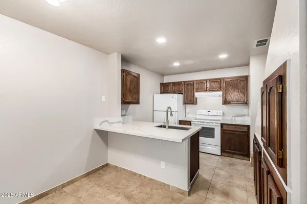 a kitchen with stainless steel appliances a sink stove and refrigerator