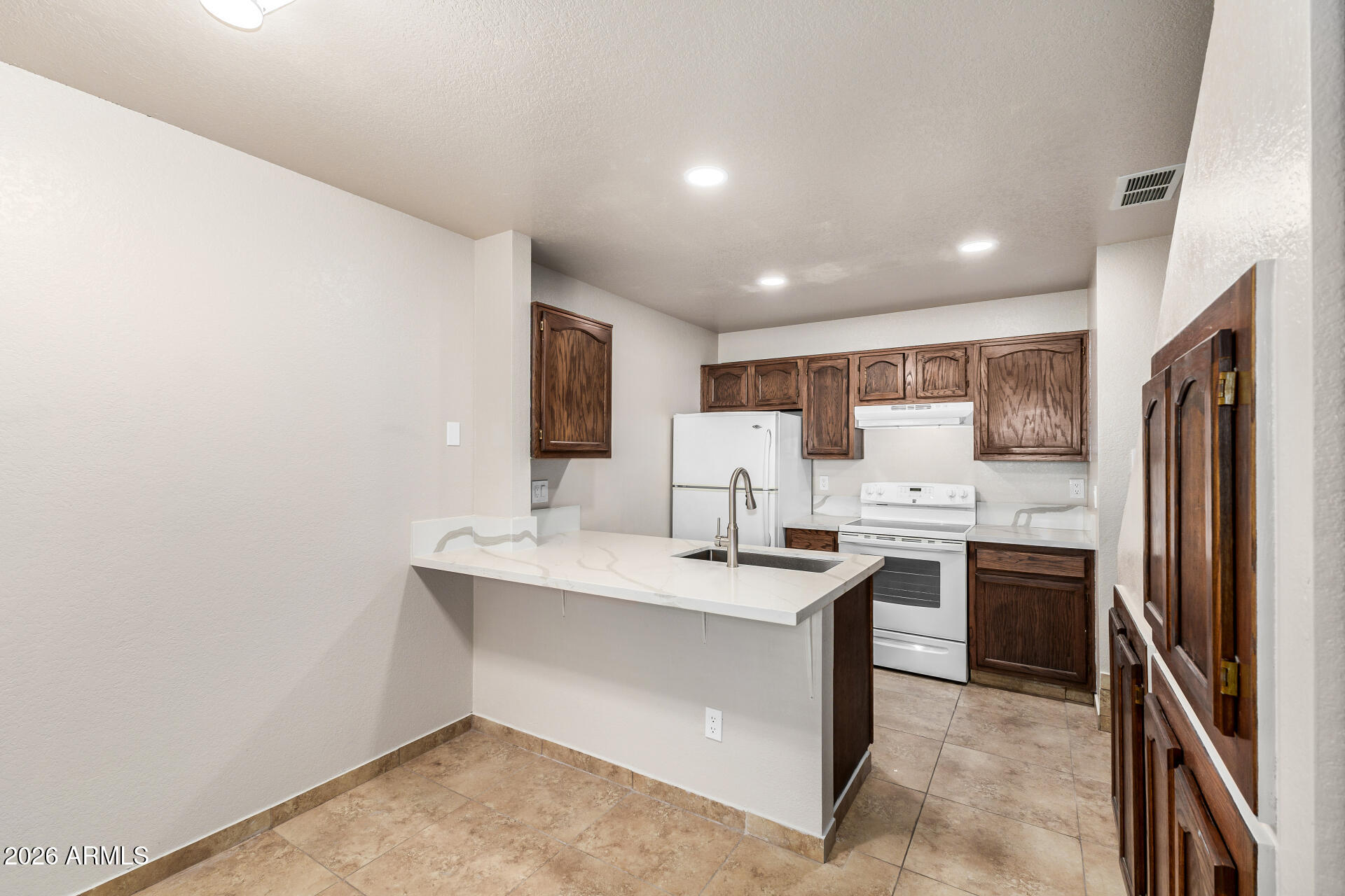 510 North Alma School Road, Unit 159 Mesa, AZ 85201 - Photo 7 of 31 a kitchen with stainless steel appliances a sink stove and refrigerator