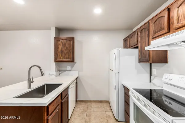 a kitchen with a sink and a refrigerator