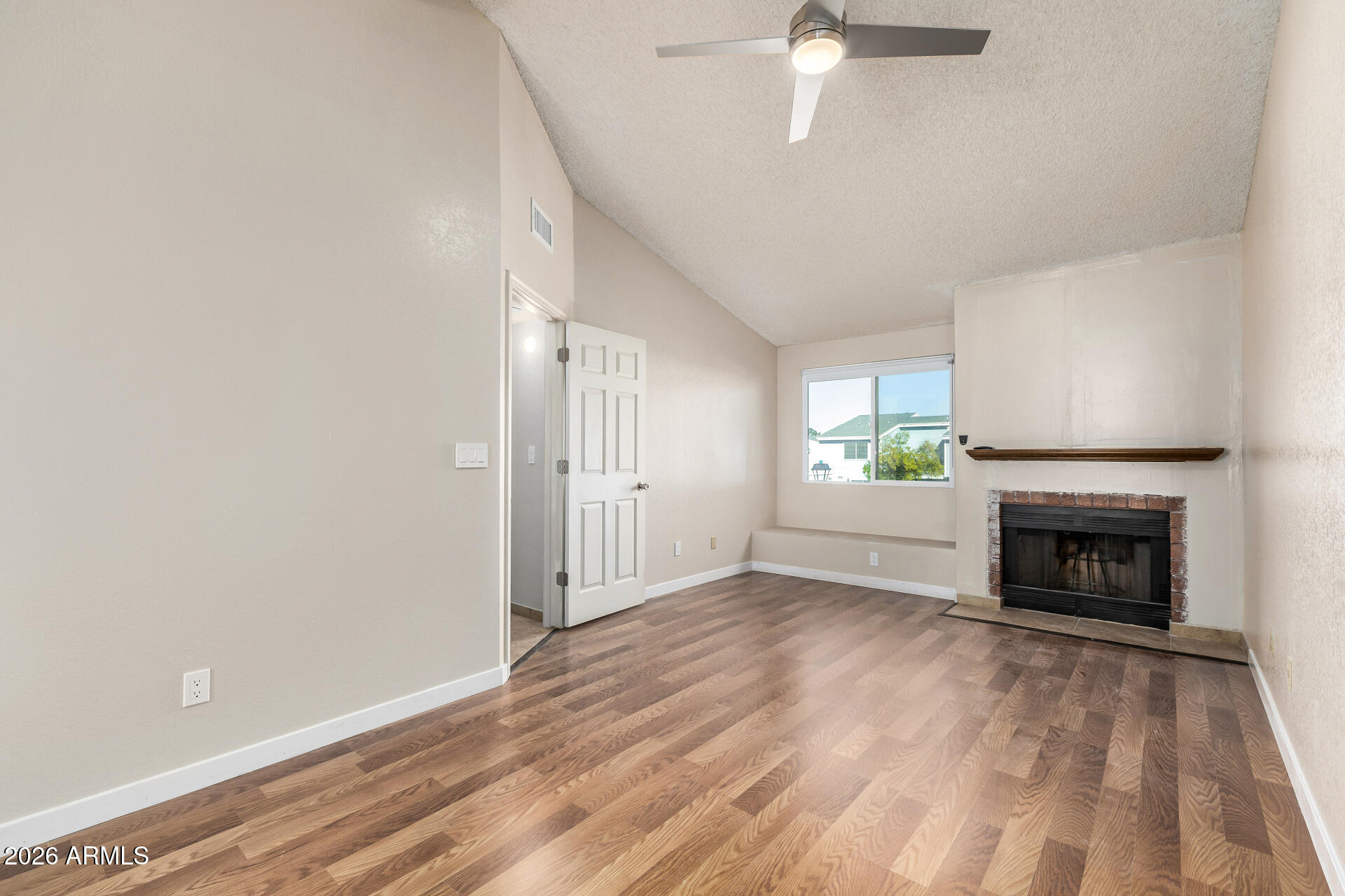 510 North Alma School Road, Unit 159 Mesa, AZ 85201 - Photo 10 of 31 a view of an empty room with a fireplace and a window