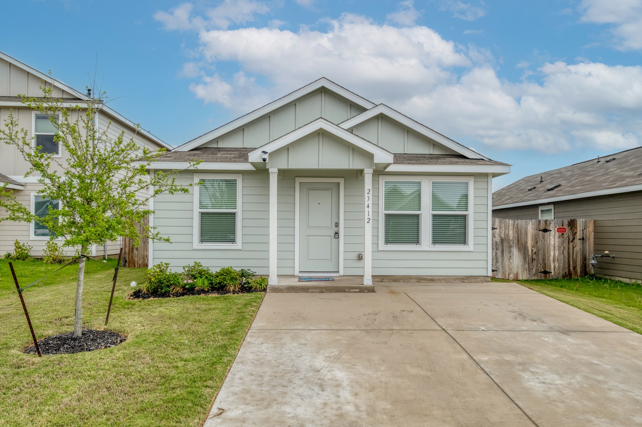 23412 Tiny Moons Way Elgin, TX 78621 - Photo 2 of 38 Single-story residence featuring light-colored siding and a covered front porch