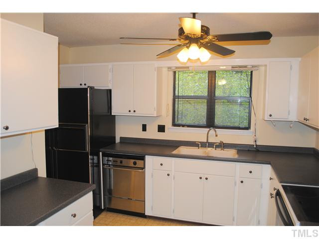 5745 3 Oaks Drive Raleigh, NC 27612 - Photo 3 of 12 a kitchen with a sink refrigerator and window