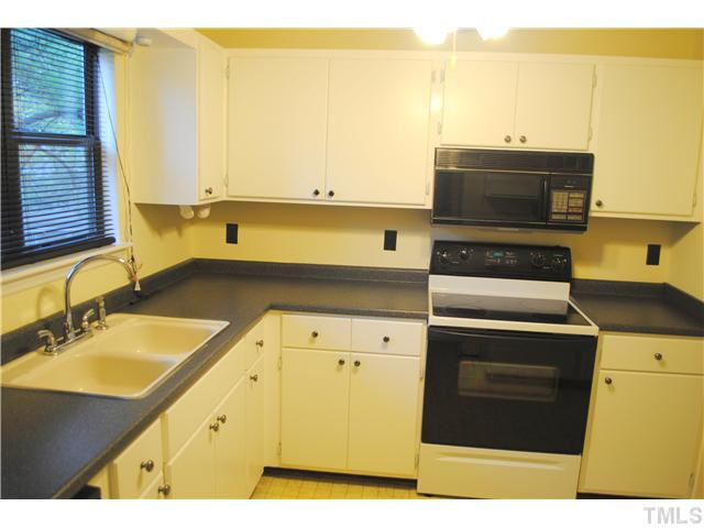 5745 3 Oaks Drive Raleigh, NC 27612 - Photo 4 of 12 a kitchen with a sink and cabinets