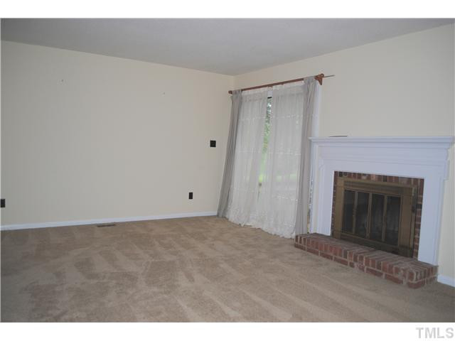 5745 3 Oaks Drive Raleigh, NC 27612 - Photo 6 of 12 a view of an empty room with a fireplace