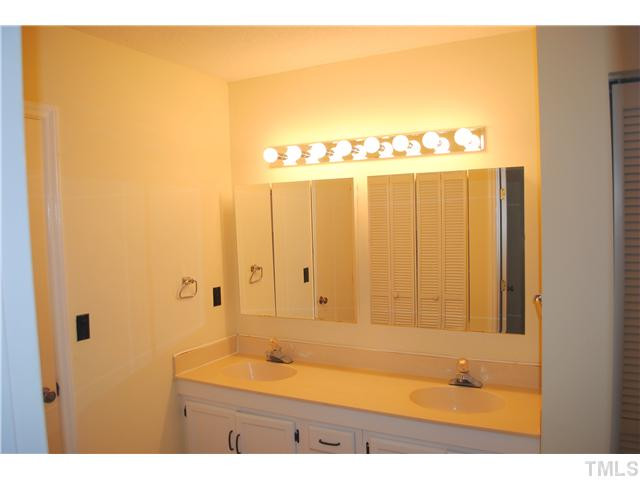 5745 3 Oaks Drive Raleigh, NC 27612 - Photo 10 of 12 a bathroom with a bathtub and a sink