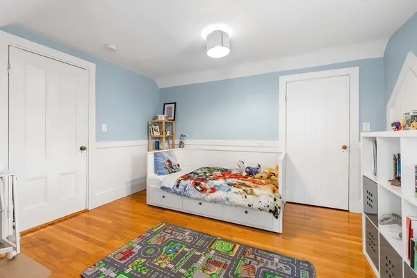 a bedroom with a bed and a book shelf
