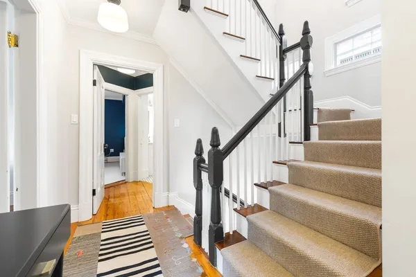 a view of staircase with wooden floor and chair
