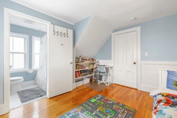 a bedroom with a bed and a tv on the dresser