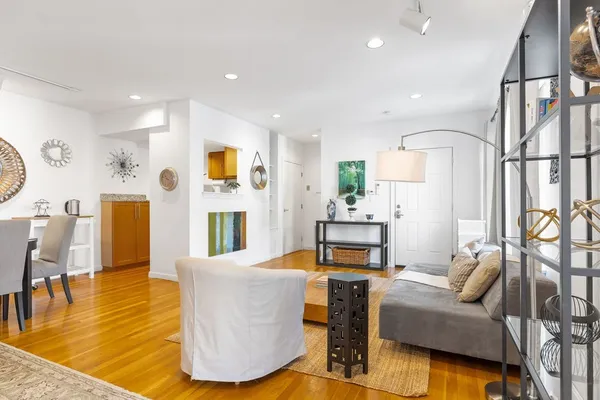 a living room with furniture and a wooden floor