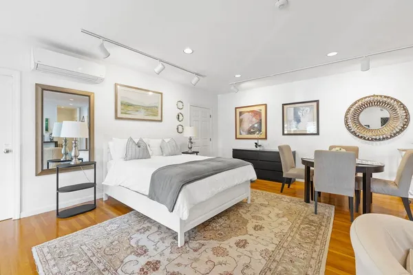 a bedroom with a bed a table and chair