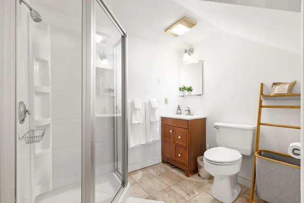 a bathroom with a toilet a sink and a mirror