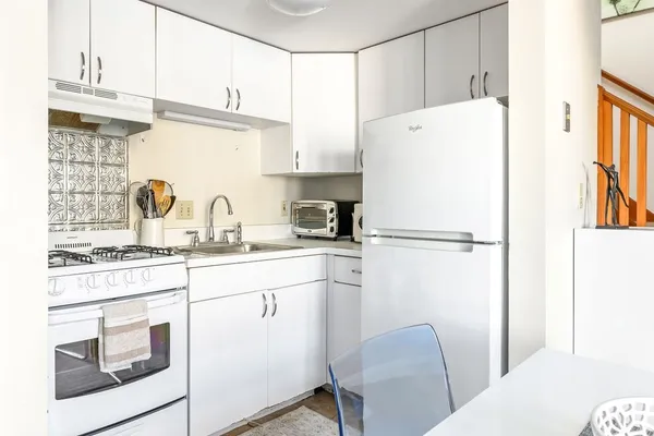 a kitchen with stainless steel appliances a refrigerator sink and cabinets