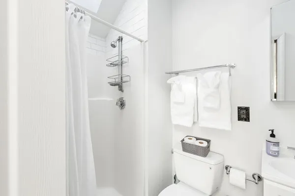 a white toilet sitting next to a bathroom sink