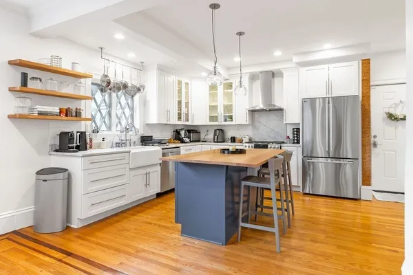 a kitchen with a refrigerator a sink and cabinets