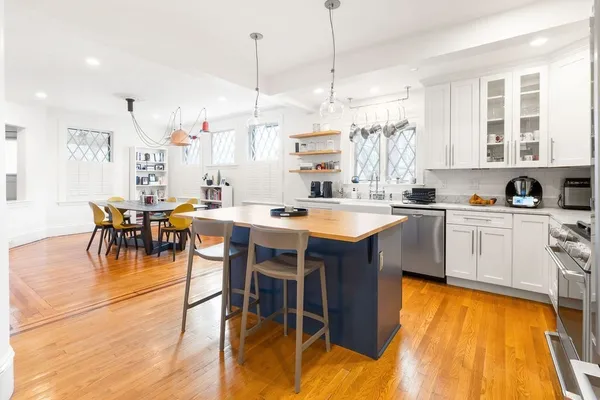 a kitchen with a sink a stove and chairs
