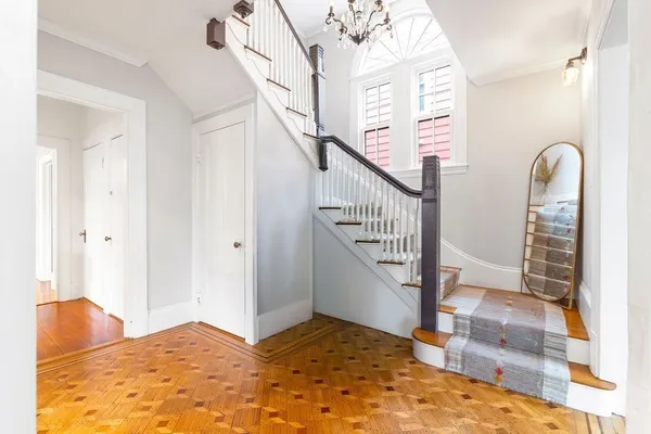 a view of entryway and hall with wooden floor