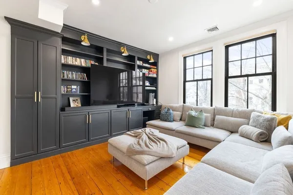 a living room with furniture and walk in closet