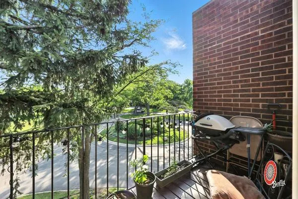 a view of a chairs and table in the balcony