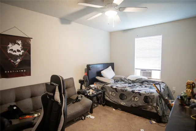 a bedroom with bed and a window