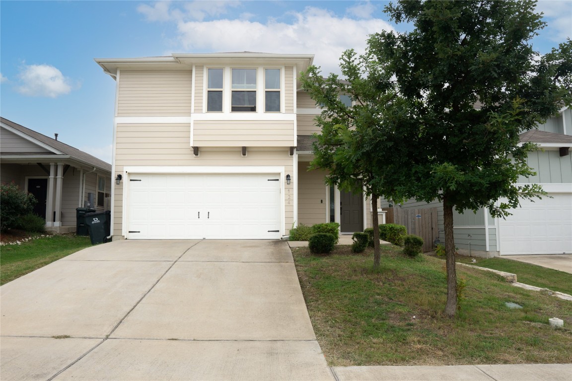 124 Guemal Road Buda, TX 78610 - Photo 2 of 14 a front view of a house with garden