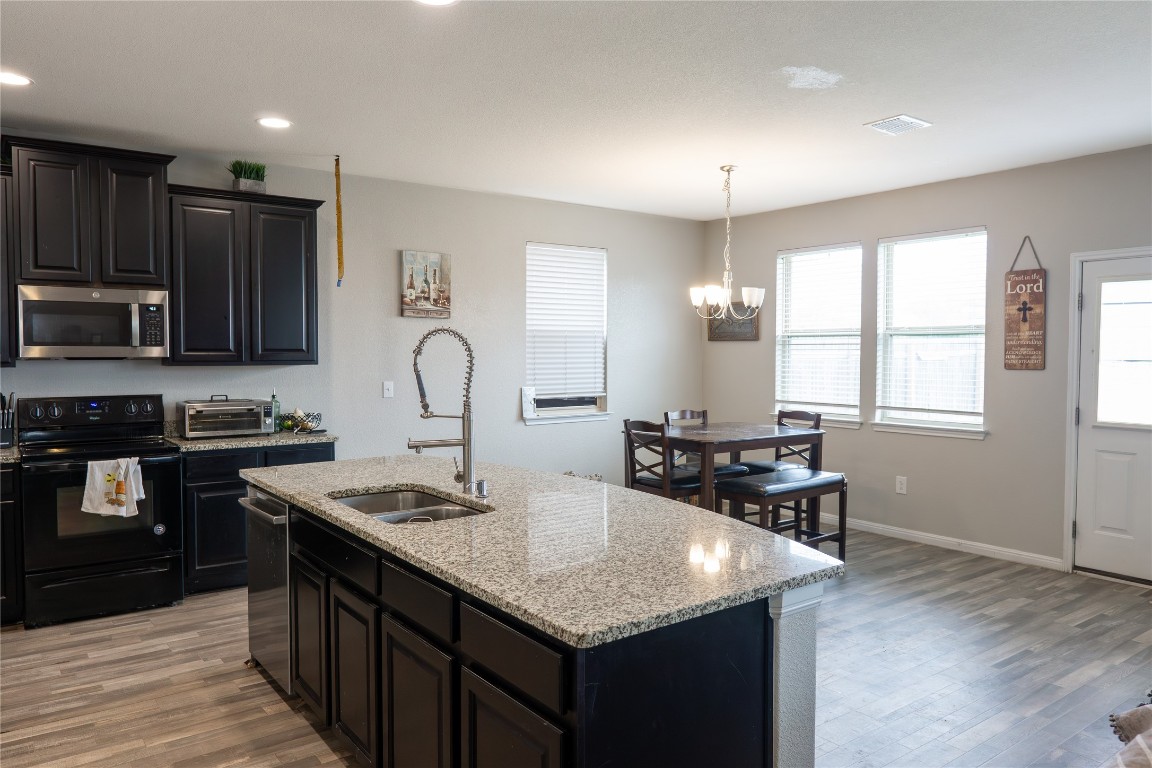 124 Guemal Road Buda, TX 78610 - Photo 6 of 14 a kitchen with counter space cabinets and appliances