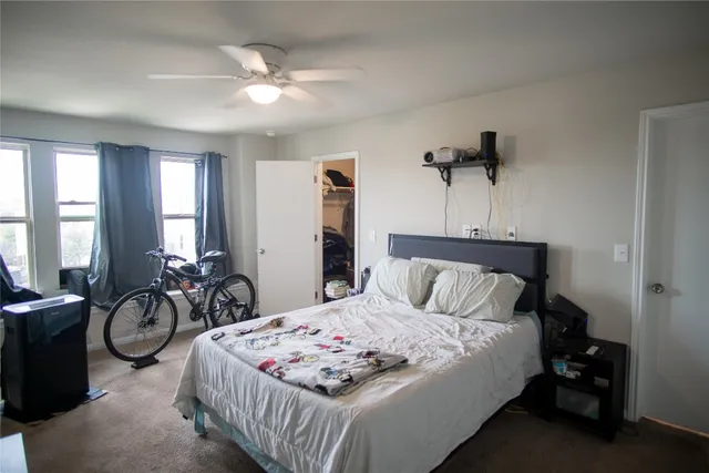 a bedroom with a bed and a chandelier