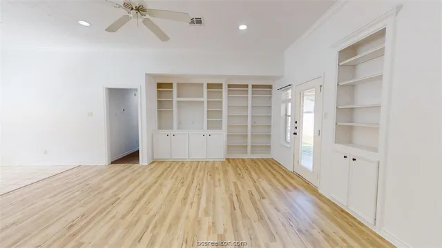 wooden floor in an empty room with a window