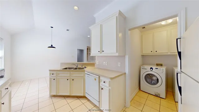 a kitchen with a sink a stove and cabinets