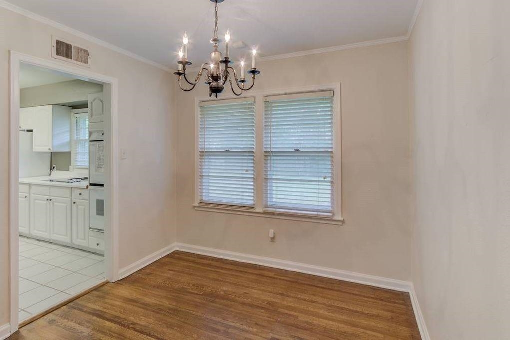 4811 Mockingbird Lane Memphis, TN 38117 - Photo 11 of 19 a view of an empty room with a window and wooden floor