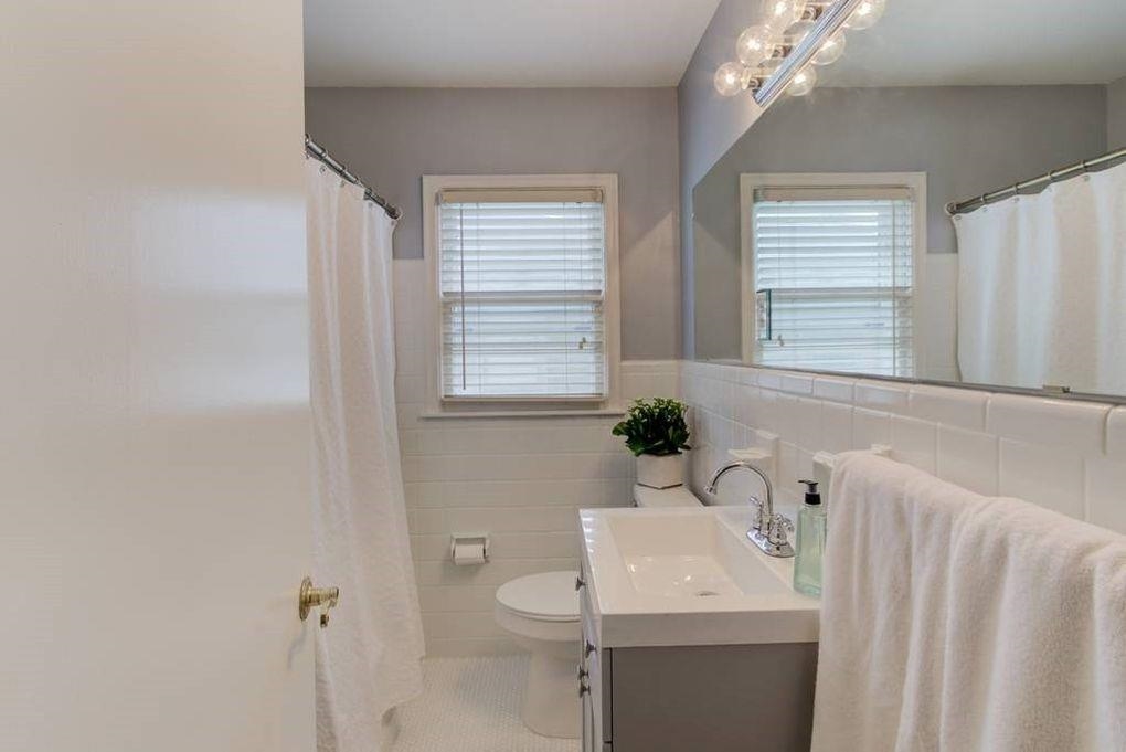 4811 Mockingbird Lane Memphis, TN 38117 - Photo 12 of 19 a bathroom with a sink a toilet and a mirror