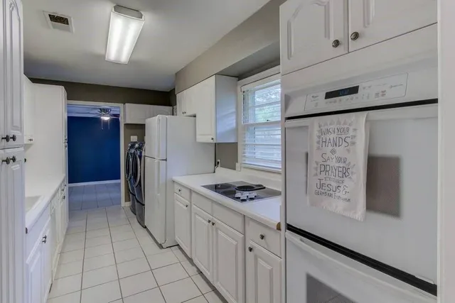 a view of a hallway with washer and dryer