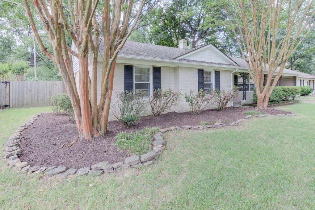 4811 Mockingbird Lane Memphis, TN 38117 - Photo 2 of 19 a front view of a house with a garden and yard