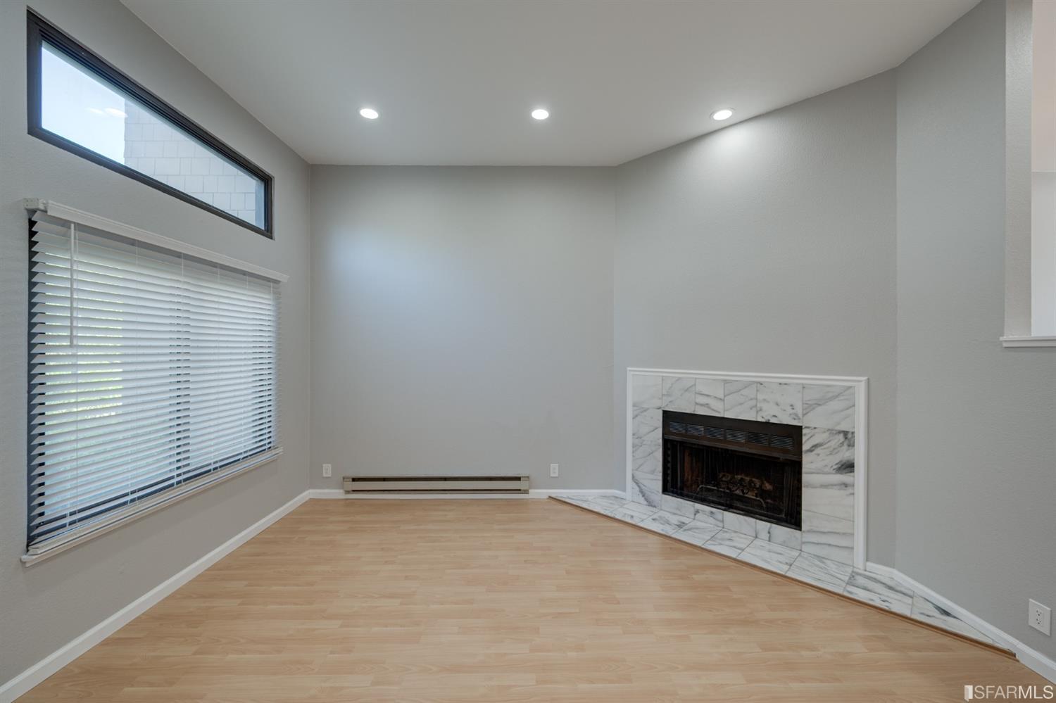 511 King Drive, Unit 5 Daly City, CA 94015 - Photo 11 of 51 an empty room with a fireplace and window