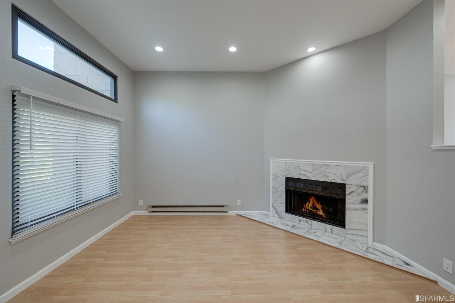 511 King Drive, Unit 5 Daly City, CA 94015 - Photo 12 of 51 an empty room with a fireplace and window