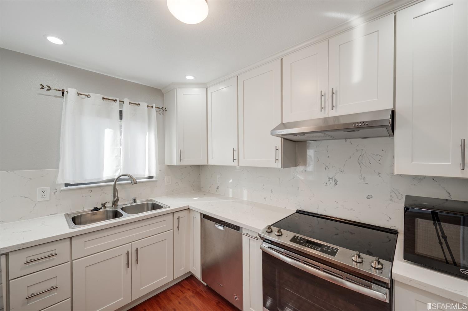 511 King Drive, Unit 5 Daly City, CA 94015 - Photo 20 of 51 a kitchen with granite countertop a sink stove and cabinets