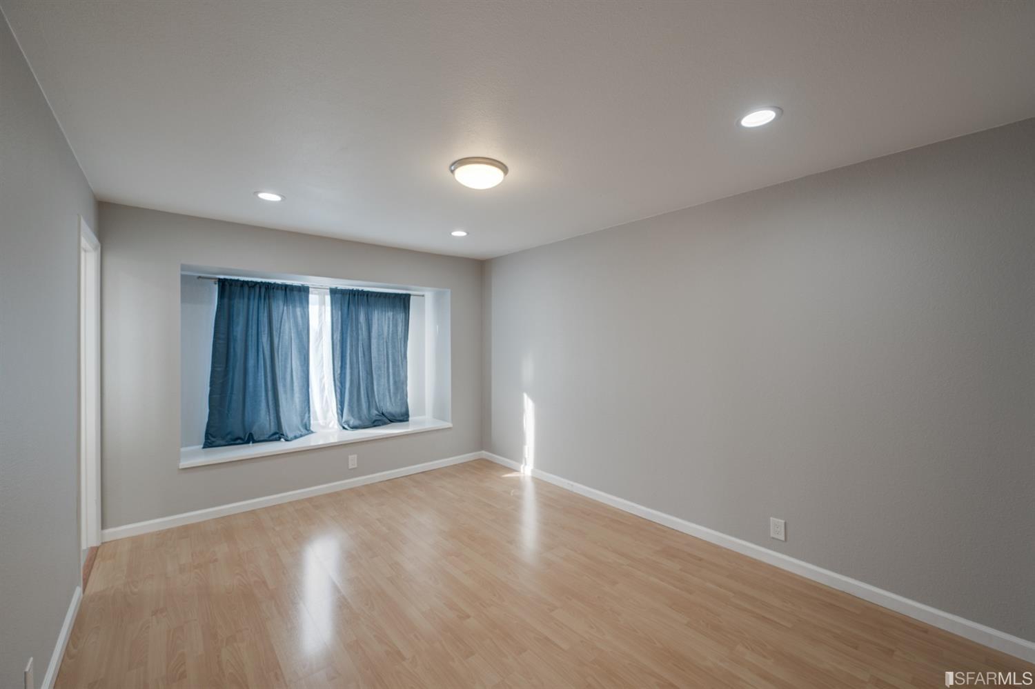 511 King Drive, Unit 5 Daly City, CA 94015 - Photo 42 of 51 a view of an empty room with wooden floor and a window