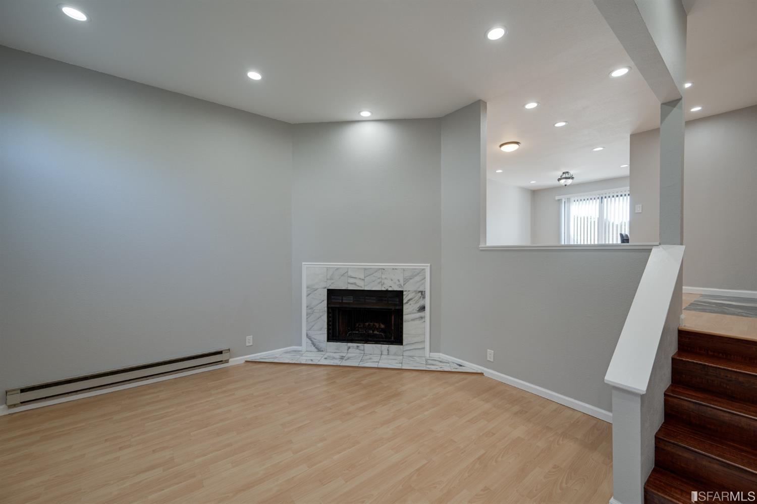 511 King Drive, Unit 5 Daly City, CA 94015 - Photo 5 of 51 a view of an empty room with wooden floor and a kitchen