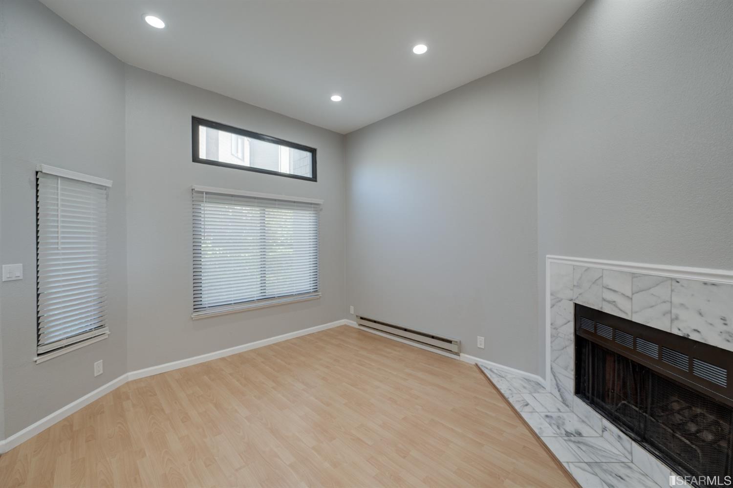 511 King Drive, Unit 5 Daly City, CA 94015 - Photo 9 of 51 an empty room with windows and fireplace