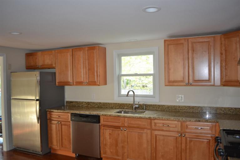 17 Wolley Road Hyannis, MA 02601 - Photo 3 of 11 a kitchen with stainless steel appliances granite countertop a refrigerator sink and cabinets