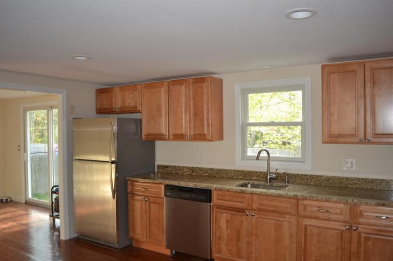 17 Wolley Road Hyannis, MA 02601 - Photo 4 of 11 a kitchen with granite countertop a refrigerator and a sink