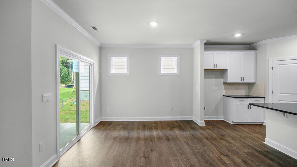 2222 Redpoll Drive Apex, NC 27539 - Photo 13 of 38 a view of a kitchen with wooden floor and electronic appliances