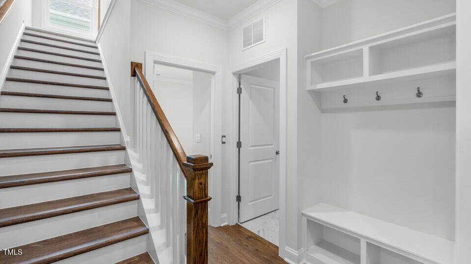 2222 Redpoll Drive Apex, NC 27539 - Photo 3 of 38 a view of entryway with wooden floor and staircase