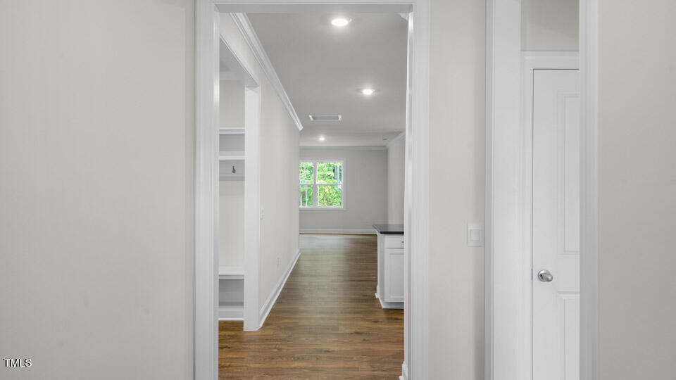 2222 Redpoll Drive Apex, NC 27539 - Photo 4 of 38 a view of a hallway with wooden floor and staircase