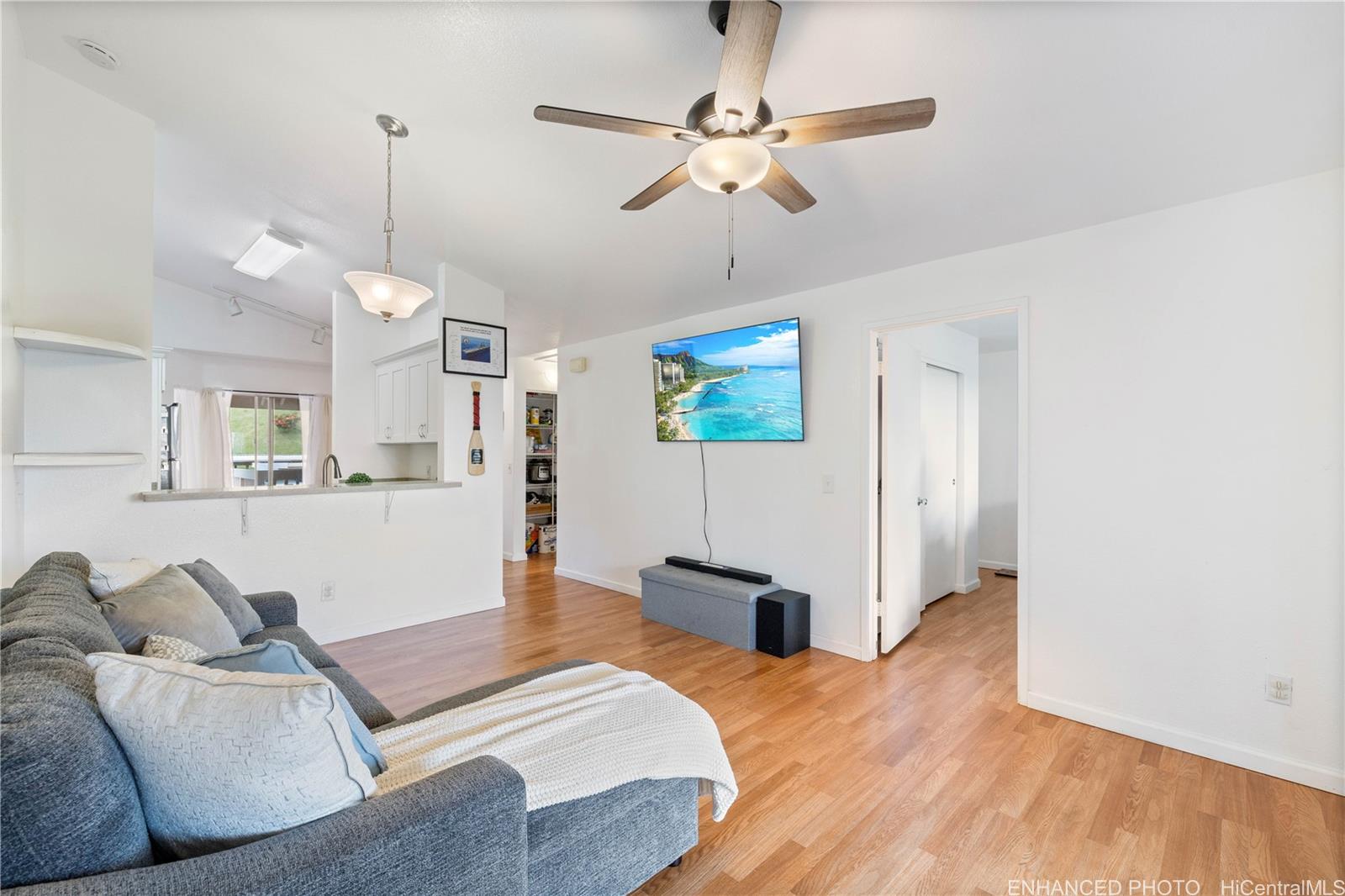 a living room with furniture and a wooden floor