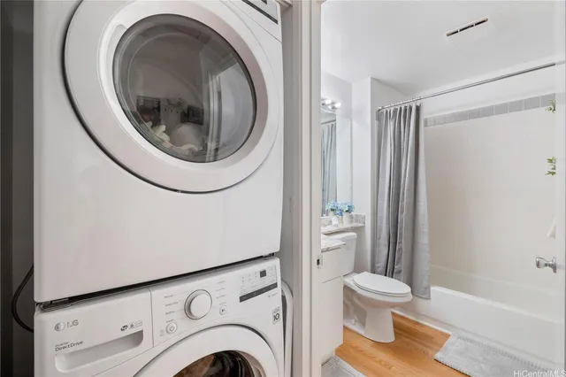 a kitchen with stainless steel appliances a refrigerator stove and wooden floor