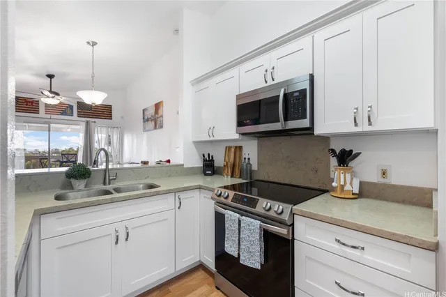 a kitchen with cabinets stainless steel appliances and a sink