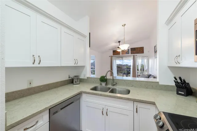a kitchen with a sink cabinets and window